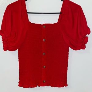 This is a red tight blouse.